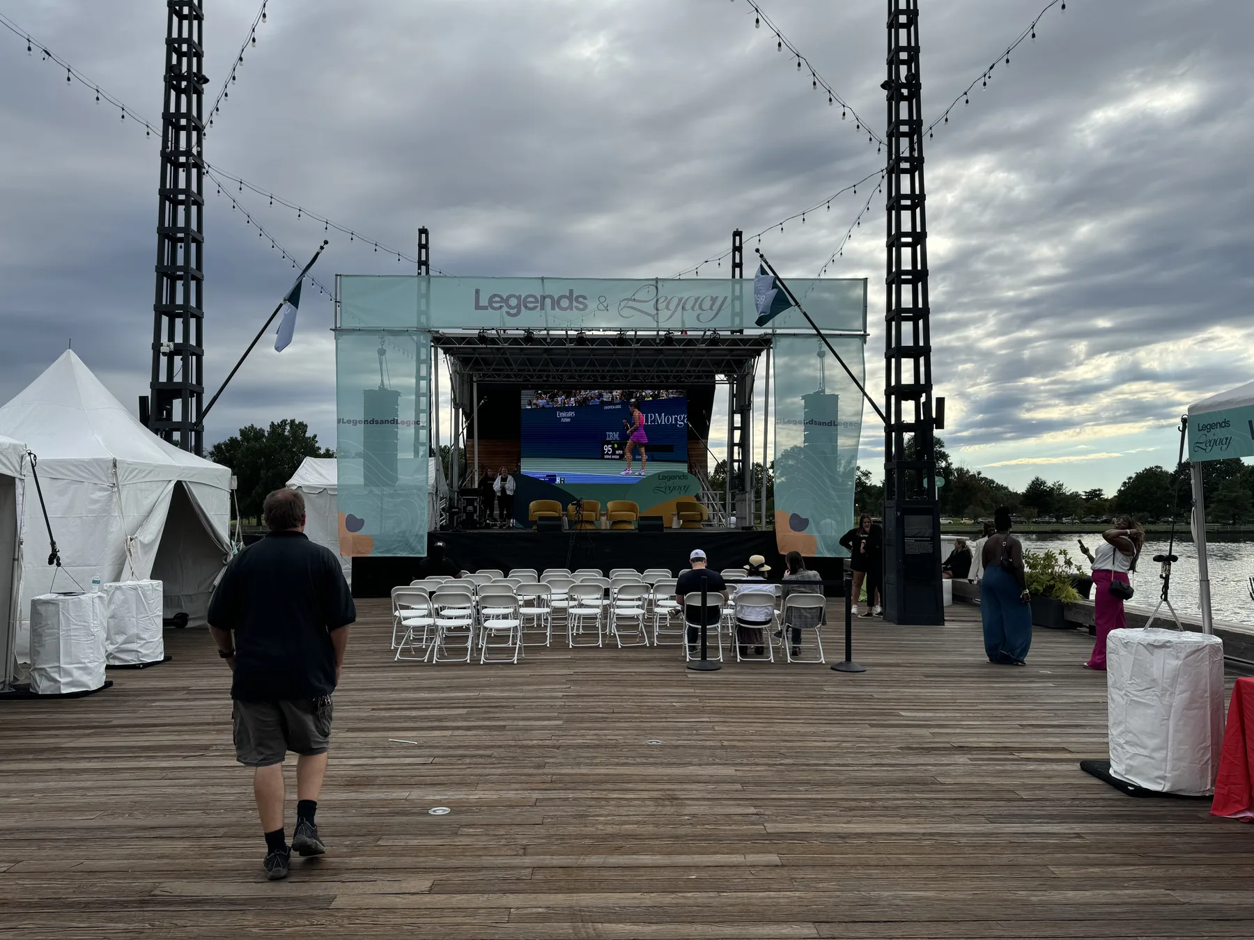 Outdoor summer stage with display screens facing the waterfront crowd