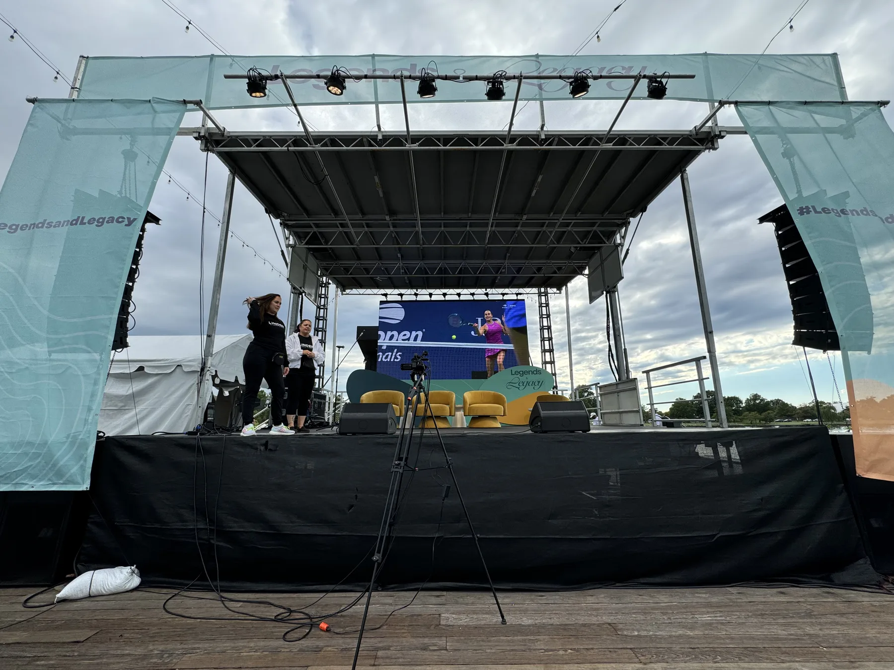 Stage and screens set against the wharf at dusk