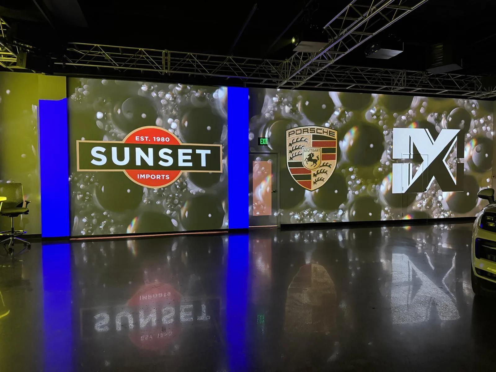 Partner event content adapted across the studio's large-format screens