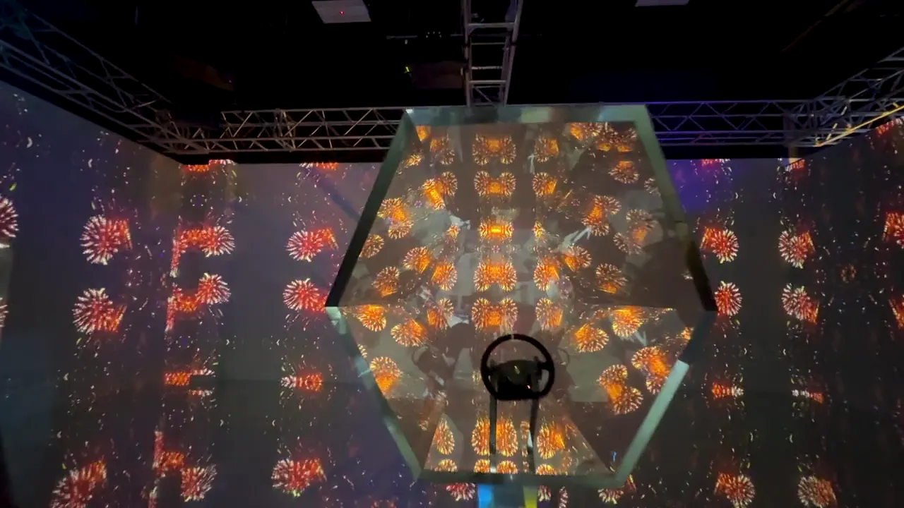 Visitors inside the glowing mirrored portal zone of the Shifting Realities installation