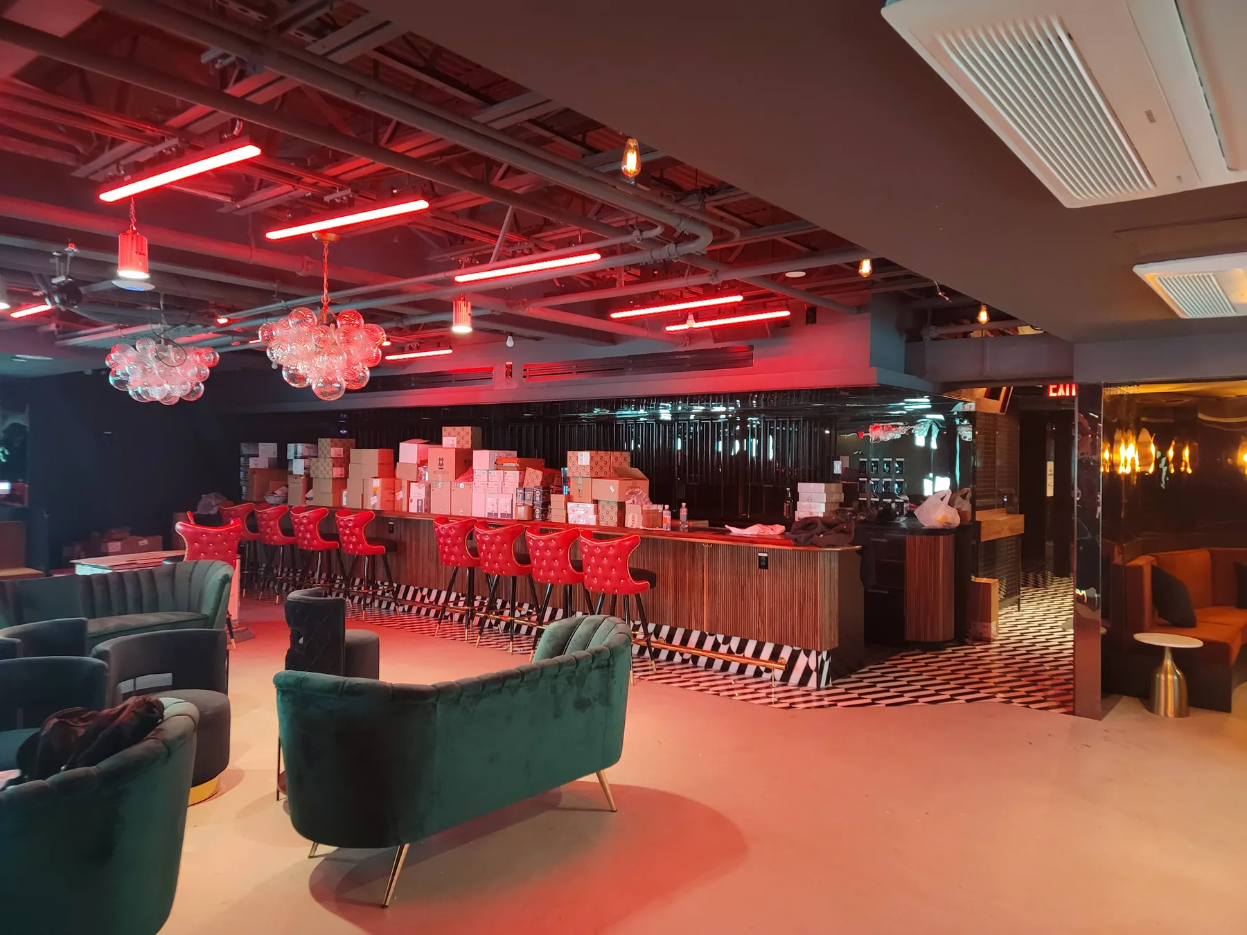 Club STFU interior saturated in neon light with screens wrapping the room
