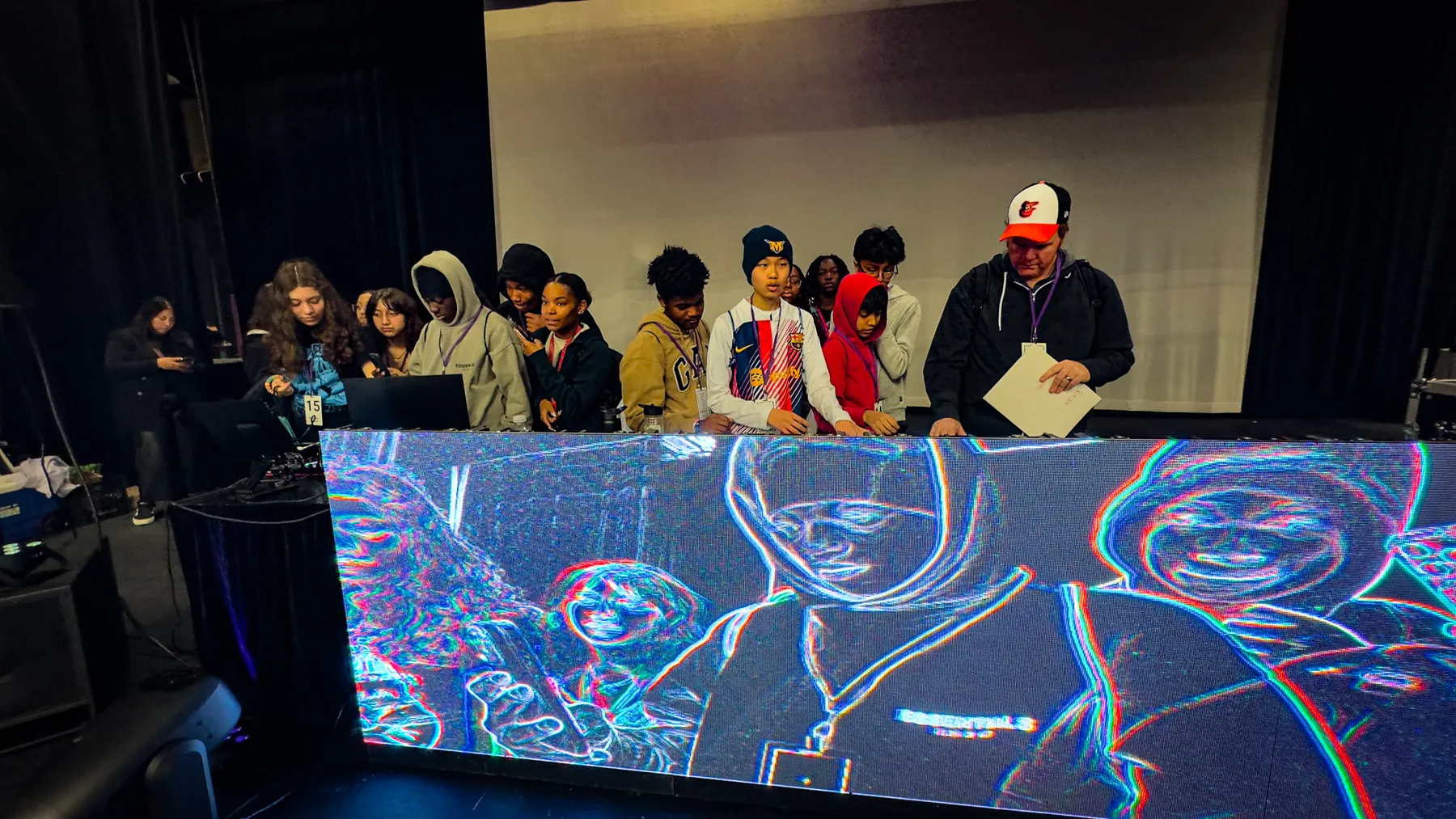 Performers silhouetted against LED wall content