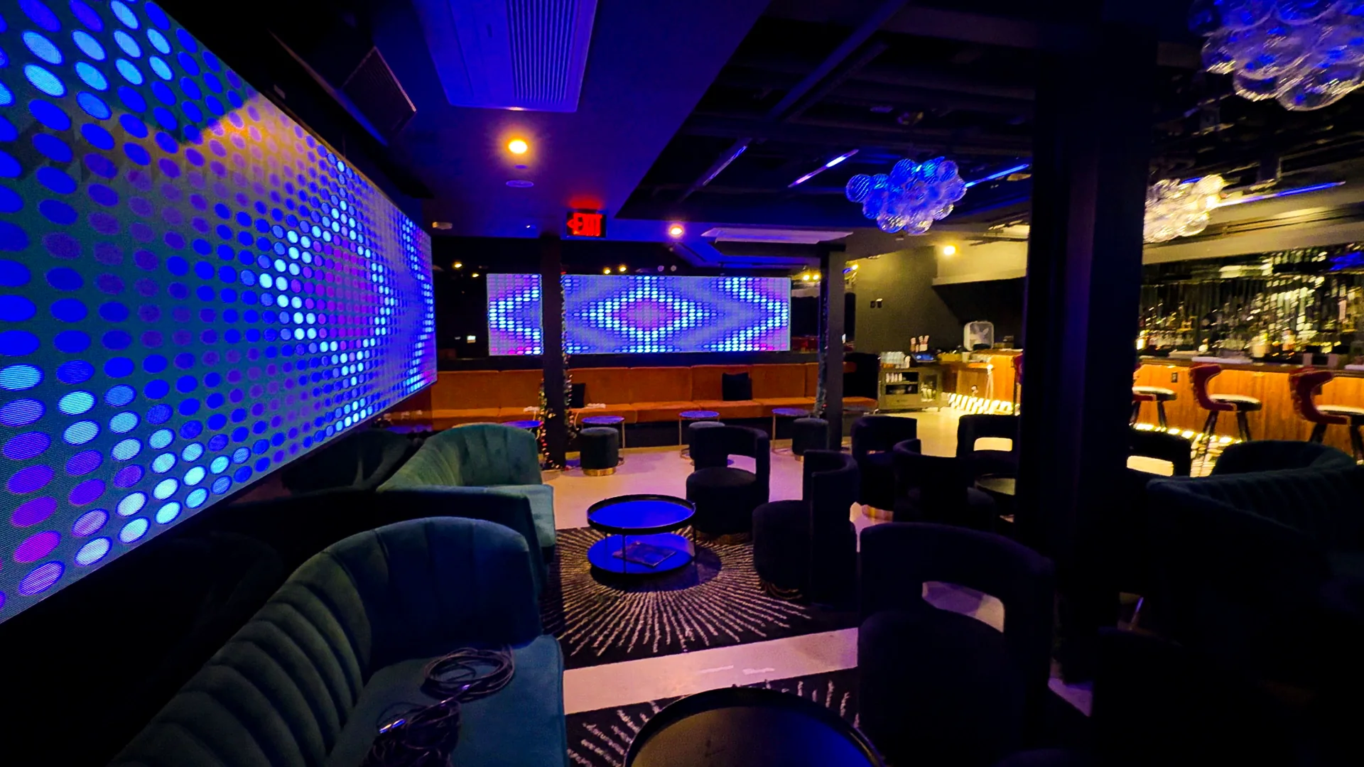 Lounge seating under the blue dot-matrix LED wall