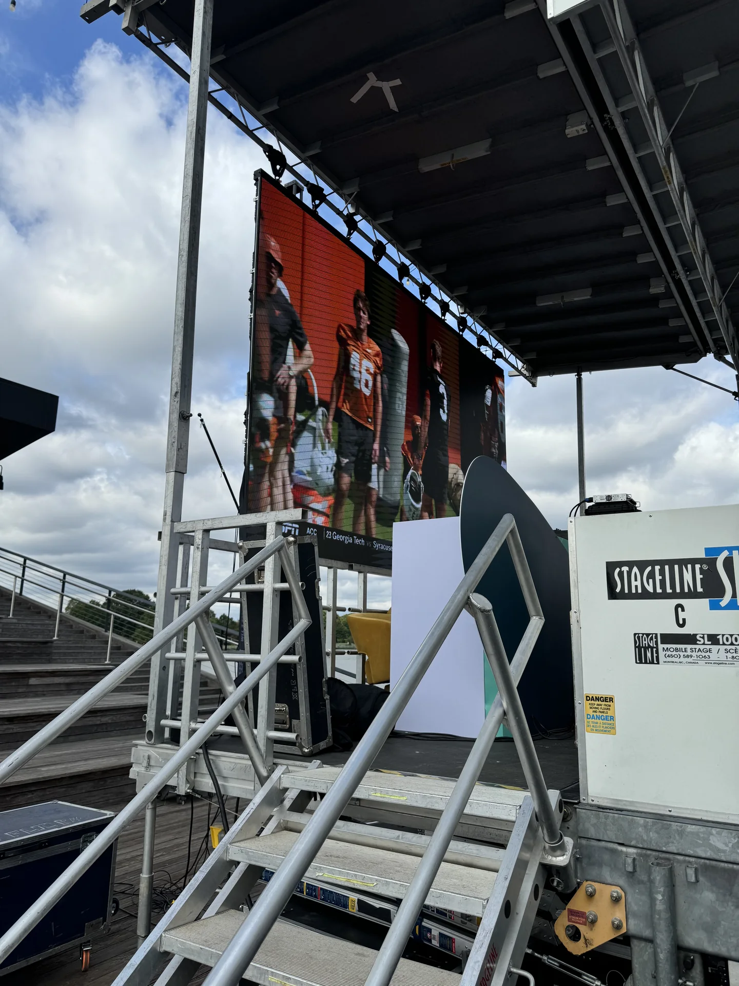 A mobile stage on the pier with access stairs, under an overcast sky
