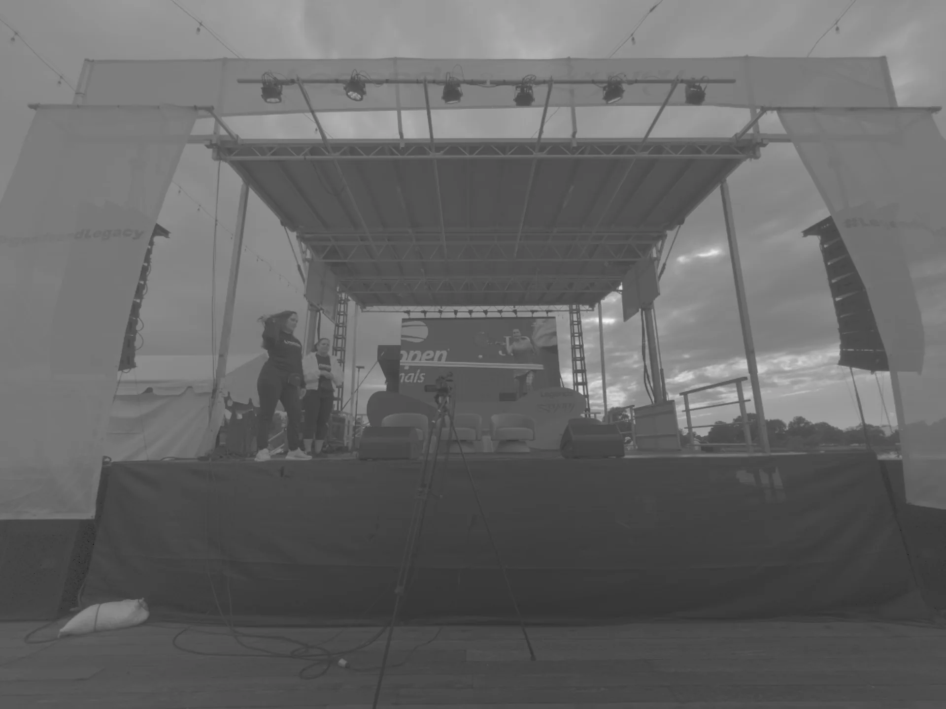 The stage screen running live content, two people near the deck