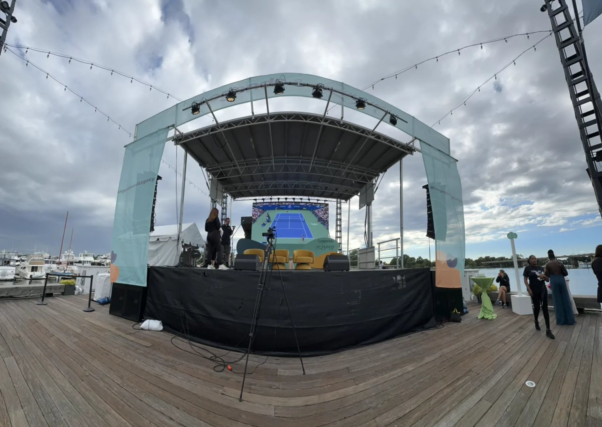 Wide view of the covered stage structure against a cloudy sky
