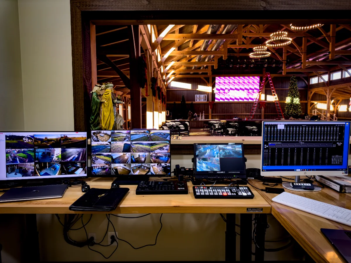 Church control position and multicam desk overlooking the barn sanctuary and 18-panel LED wall