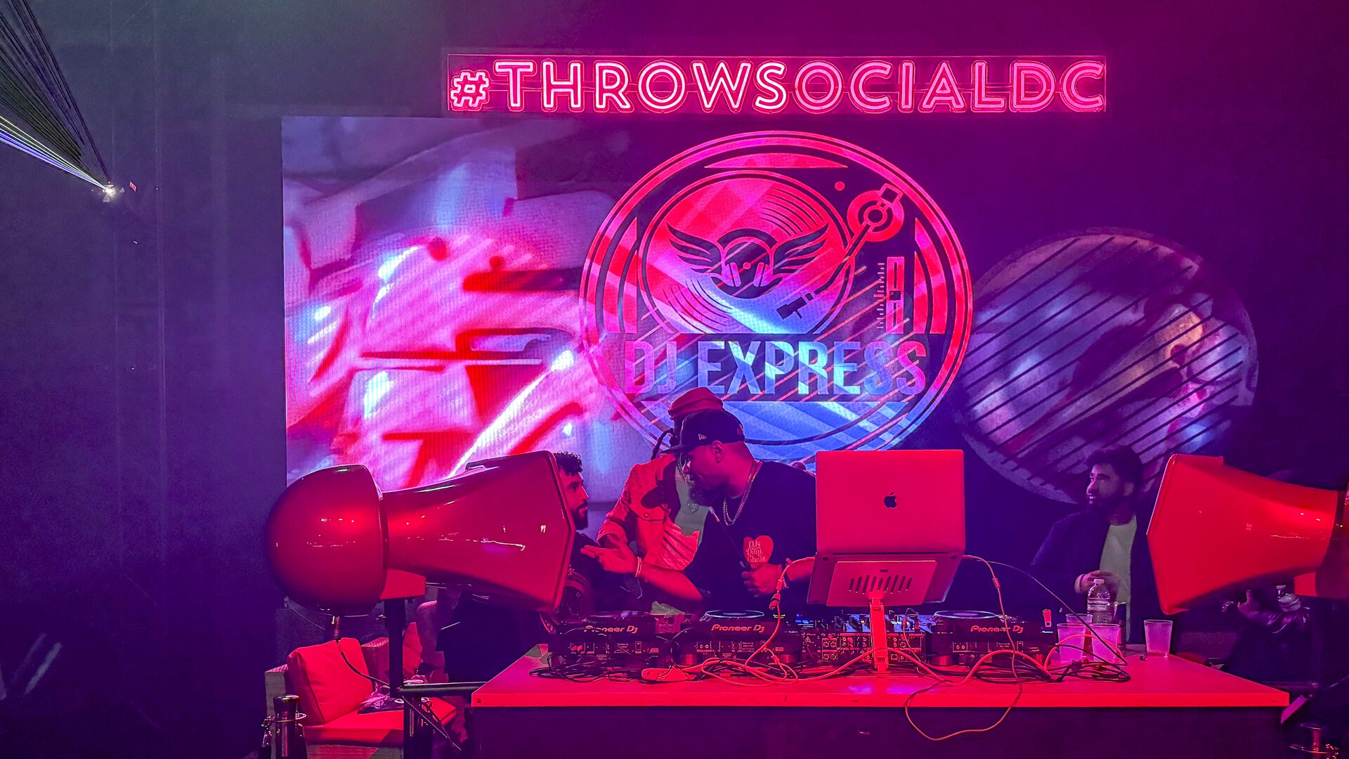 Throw Social DJ booth and LED wall running mapped content beneath the venue sign